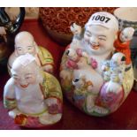 A 20th Century Chinese porcelain hotei with children figurine - sold with two smaller similar