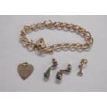 A marked 925 chain with heart shaped padlock - sold with a pair of earrings and two charms