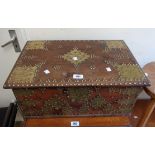 A 57cm old Zanzibar style brass mounted and studded, tray fitted hardwood lift-top box with flanking
