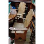 A pair of rustic mixed wood elbow chairs with wide petal backs and solid elm seats, set on shaped