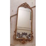 A vintage gilt resin framed ornate pier style wall mirror with shaped plate