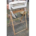 A vintage Acme aluminium mangle with chrome plated fitting on original folding stand