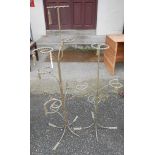 Two vintage wrought iron shop display units with rope twist design and tassel effect finials, with
