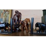 A pair of carved ebony elephant bookends - sold with two further carved elephant items