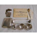 A bag containing silver collectable items including sugar tongs, vesta case, initialed napkin rings,