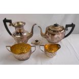 An antique style silver four piece tea and coffee set with embossed decoration and gilt interiors to