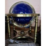 A 20th Century mixed real stone set globe of the world, set on a brass stand with compass - with