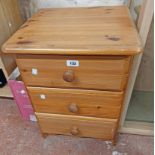A 43cm modern pine bedside chest of three long drawers, set on bracket feet