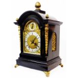 A late 19th Century gilt metal mounted ebonised cased break dome top table clock with regulator to