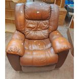 A vintage brown leatherette upholstered recliner/rocking wide frame armchair, set on metal feet -