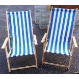 A pair of vintage style wood framed and canvas deck chairs