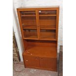 A 92cm retro teak and mixed wood cabinet with glazed doors to top, open section and pair of cupboard