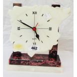 An Art Deco style mixed marble cased tim An Art Deco style mixed marble timepiece with map pattern