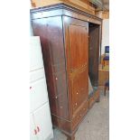 A 1.34m late Georgian mahogany double wardrobe with moulded cornice and hanging space enclosed by