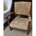 A vintage stained beech framed elbow chair with original upholstery