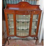 A 1.22m Edwardian mahogany and strung break bow front display cabinet with painted decoration to