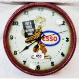A reproduction Esso painted tin dial wall timepiece with battery movement