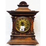 A late 19th Century stained walnut cased table clock with gilt dial and eight day gong striking