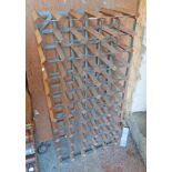 A freestanding wood and galvanised metal sixty bottle wine rack