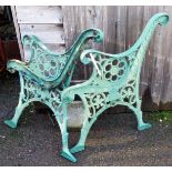 A pair of cast iron green painted garden bench ends