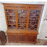 A 1.65m early 20th Century mahogany and strung two part book cabinet with adjustable shelves