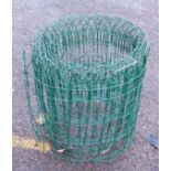 A roll of green Plasti-coated wire garden fencing