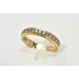 A YELLOW METAL DIAMOND HALF ETERNITY RING, designed with a row of claw set, round brilliant cut