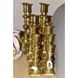 SIX PAIRS OF CAST BRASS CANDLESTICKS, four pairs of ejectors, smallest height 12.5cm, tallest height