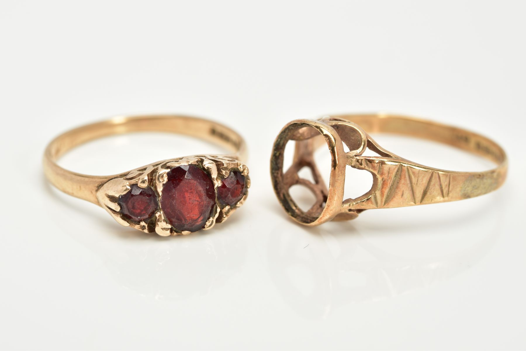 TWO 9CT GOLD RINGS, the first a graduated three stone oval cut garnet ring, within a scroll detailed - Image 2 of 3