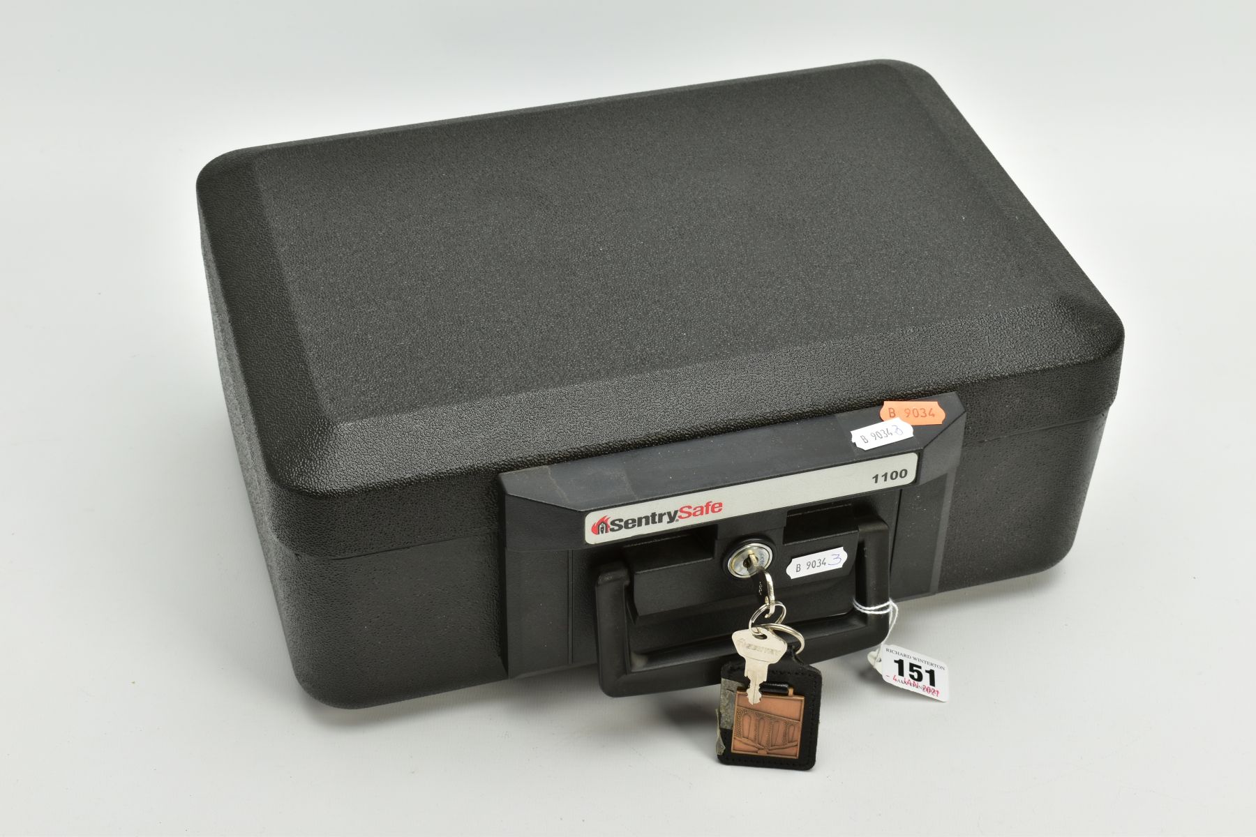 A BLACK SENTRYSAFE 1100 FIRE CHEST, fitted with a carrying handle, serial number to the inside of