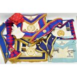 A BOX OF MASONIC REGALIA to include aprons, swags, gold plated badges and silk scarves for lodges