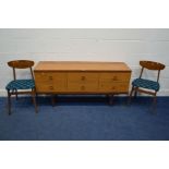 A MID 20TH CENTURY TEAK FINISH DRESSING TABLE with six drawers (no mirror) and a pair of dining
