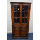 A REPRODUCTION OAK GLAZED TWO DOOR CORNER CUPBOARD, above panelled doors, width 88cm x depth 48cm