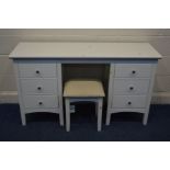 A MODERN WHITE FINISH DRESSING TABLE with six drawers, width 137cm x depth 44cm x height 77cm and
