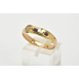 A 15CT GOLD RUBY SET RING, in the form of a buckle, set with two rectangular cut rubies,