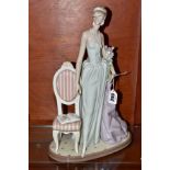 A LARGE LLADRO FIGURINE, 'A lady of Taste' No 1495, elegant lady stood by chair holding flowers,