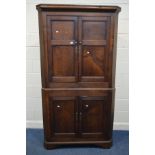 A GEORGIAN OAK FLOORSTANDING CORNER CUPBOARD with four panelled cupboard doors, width 111cm x