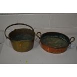 A COPPER PAN, with twin hooped handles, and a brass jam pan (2)