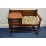 AN OLD CHARM OAK TELEPHONE TABLE/SEAT with a single cupboard door