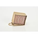 A 9CT GOLD CASED TEN SHILLING NOTE CHARM, the folded note within a plain polished square case and