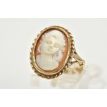 A 9CT GOLD CAMEO RING, of oval design depicting a lady in profile, within a collet mount and rope