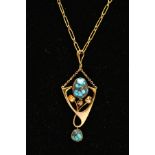 A YELLOW METAL TURQUOISE PENDANT NECKLACE, the pendant of an openwork floral drop design, set with a
