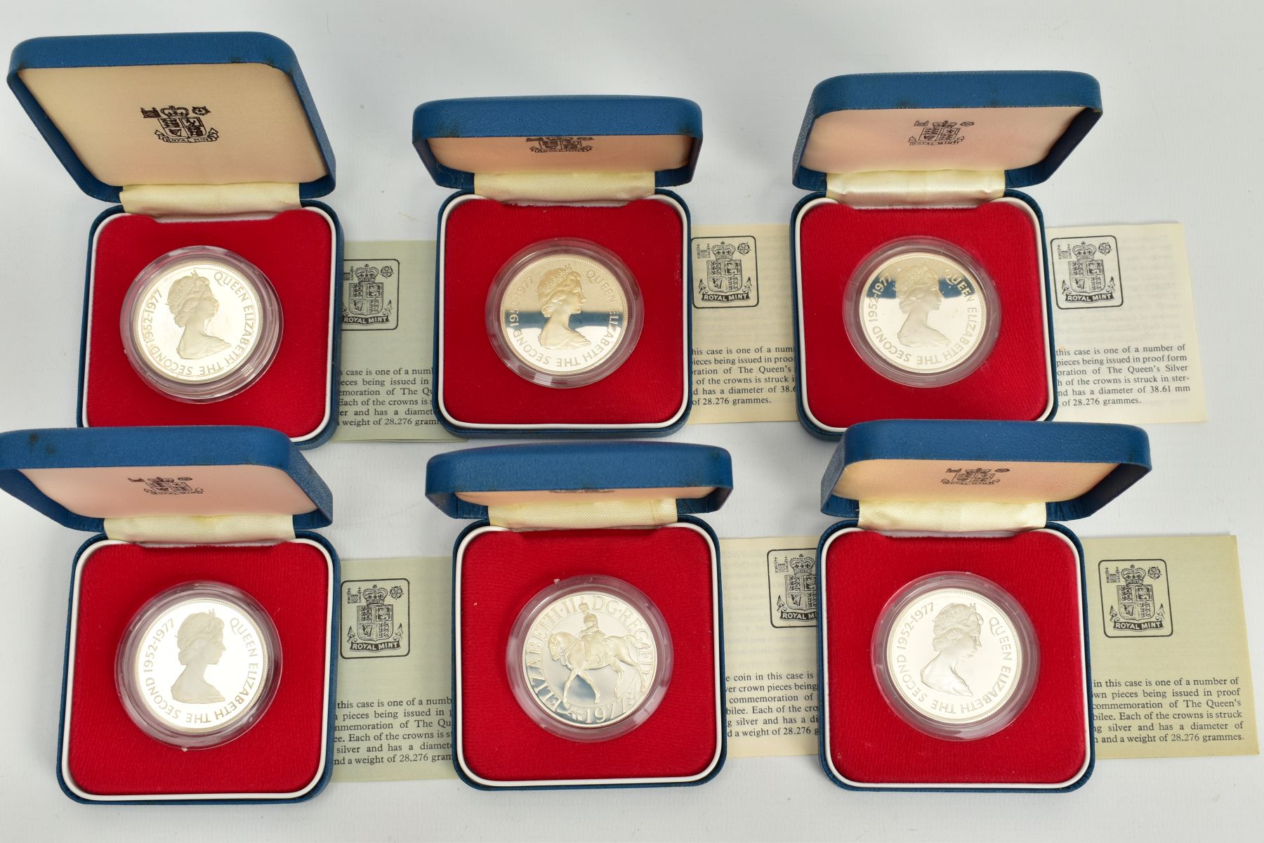 A SET OF SIX INDIVIDUALLY CASED 1952-1977 COMMEMORATIVE COINS, each with a design of the issuing