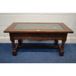 AN OLD CHARM OAK COFFEE TABLE with a drop in glass centre, on turned legs united by a stretcher,