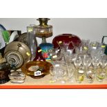 A GROUP OF GLASSWARE, etc, including three various oil lamps, a red glass light shade, a vintage