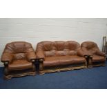 AN OAK FRAMED AND BROWN LEATHER THREE PIECE LOUNGE SUITE, comprising a three seater settee and a