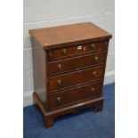 A SMALL REPRODUCTION MAHOGANY CHEST OF FOUR DRAWERS, with a forward fold over top, width 59cm x