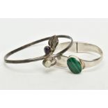 A SILVER MALACHITE SET BANGLE AND A WHITE METAL ARM CUFF, the hinged bangle set with an oval