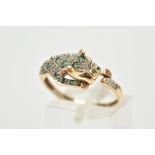 A 9CT GOLD, EMERALD AND DIAMOND PANTHER RING, in the form of a leaping panther set with a circular