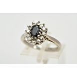 AN 18CT WHITE GOLD SAPPHIRE AND DIAMOND CLUSTER RING, the raised cluster designed with a central